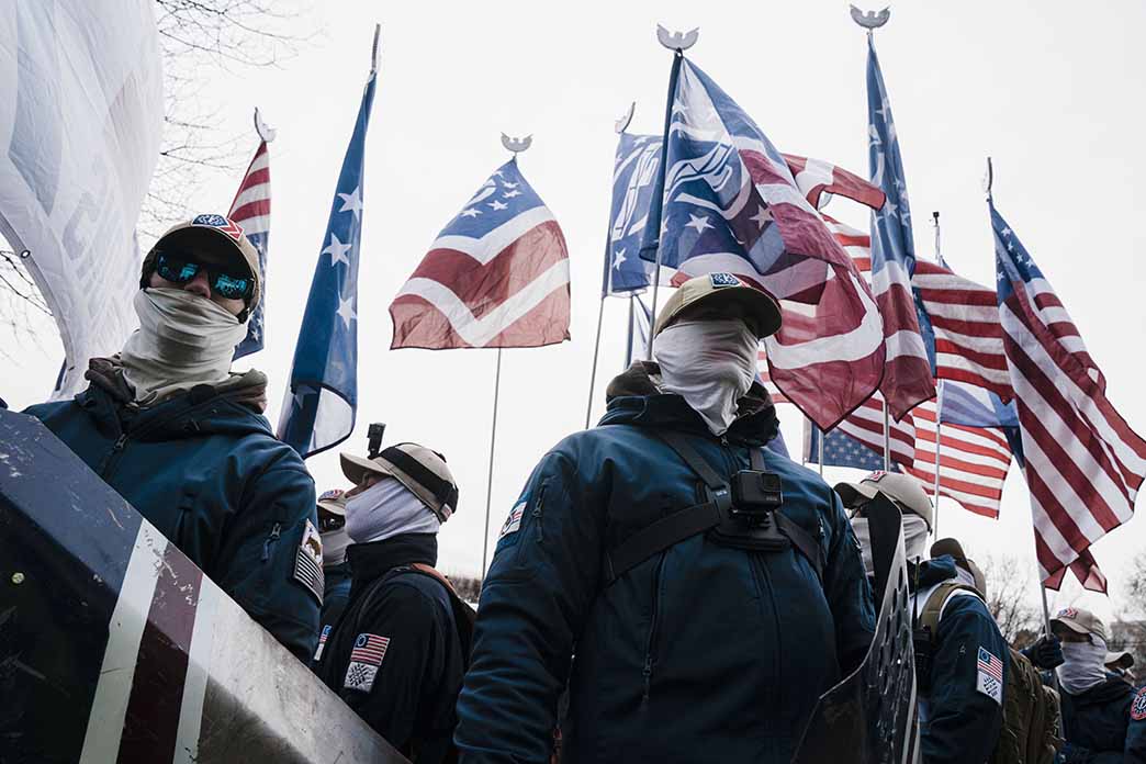 Members of the white nationalist Patriot Front under U.S. and other flags