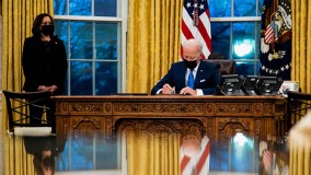 President Joe Biden signs and executive order in White House Oval Office
