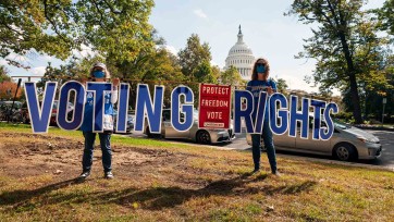 People hold voting rights sign